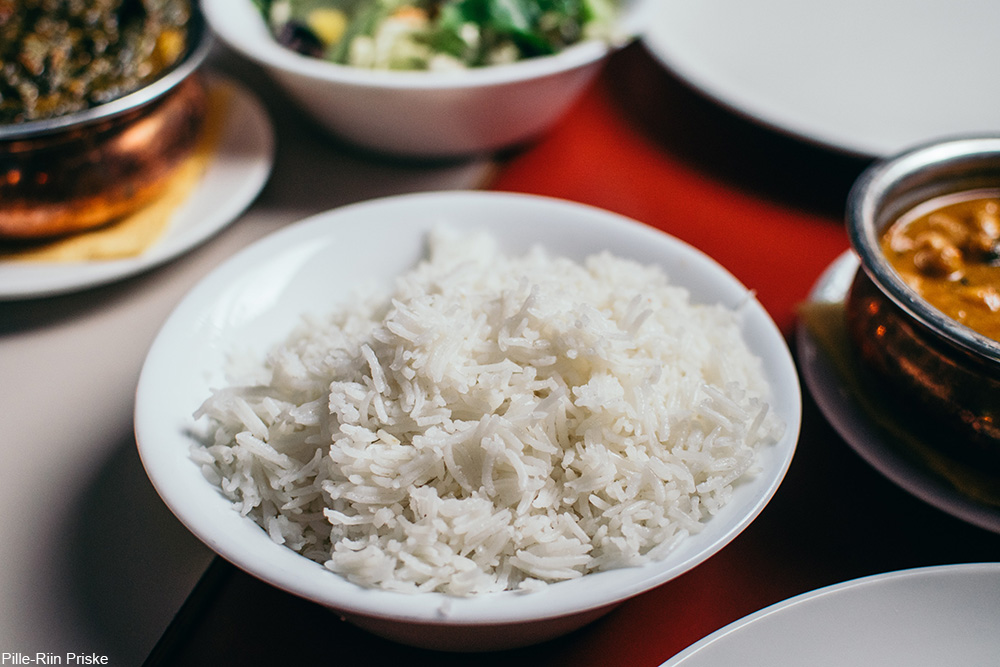 fluffy rice on a table with other prepared dishes