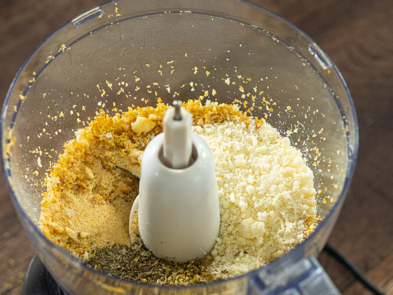 Place croutons in a food processor and pulse until crumbled. Add oregano, basil, garlic powder, onion powder, and 1/4 cup Parmesan. Pulse to mix. Pour into a shallow bowl.