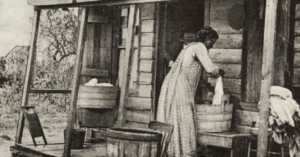 black and white photo of an American settler woman doing laundry