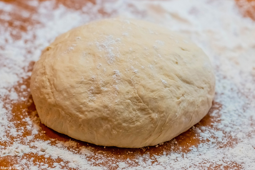 bread dough on floured wooden board