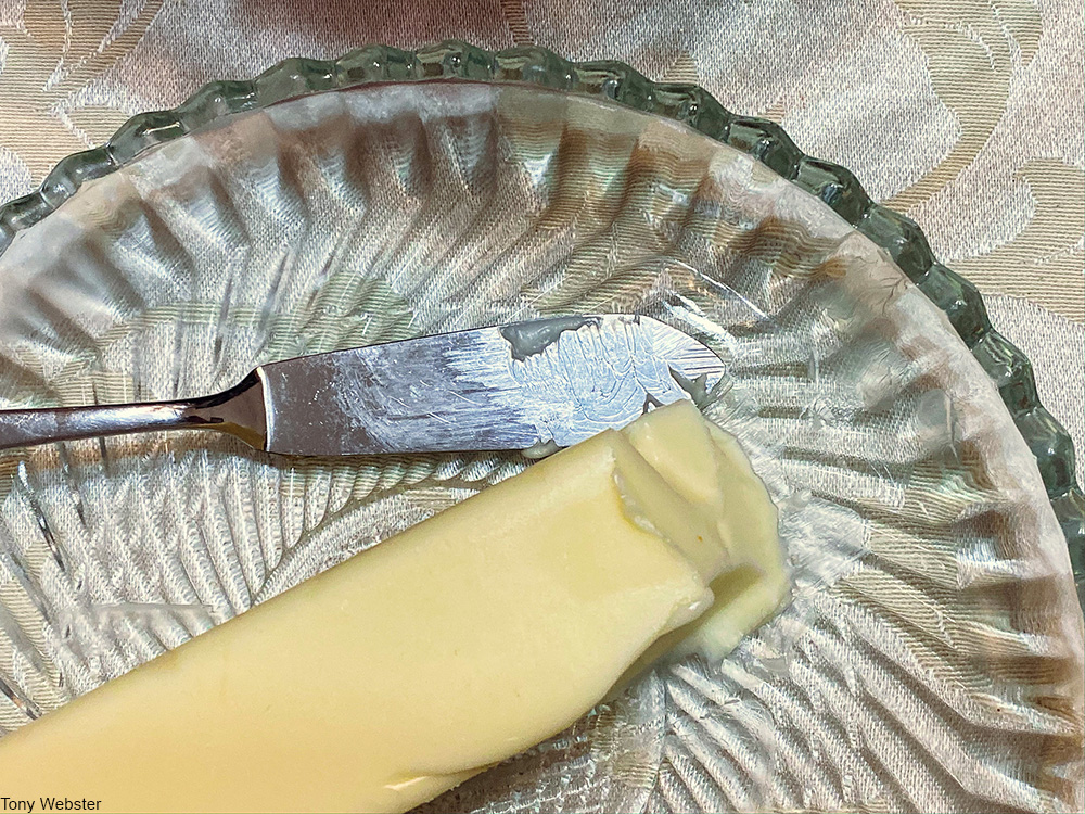 stick of room temperature butter on glass plate