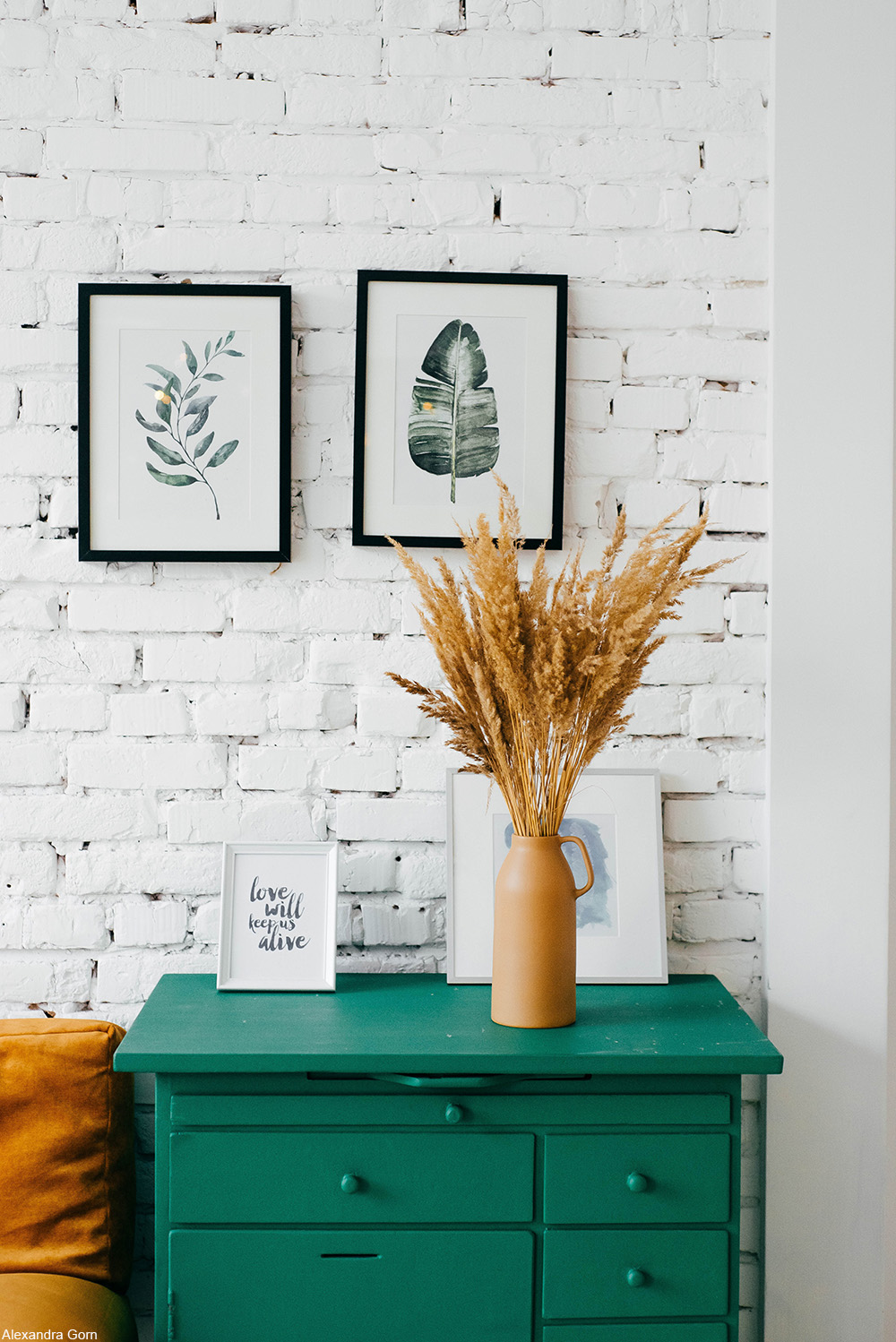 living room with white brick wall and teal accents