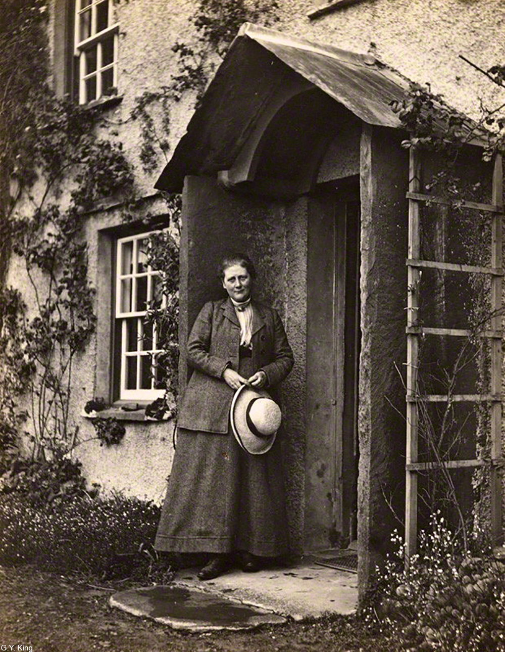 Beatrix Potter on the stoop of Hill Top house, Cumbria