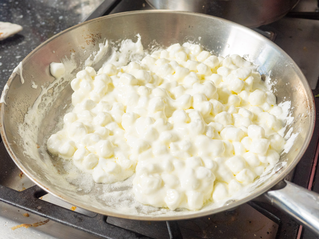 Melt the butter in a large pot over medium heat, then stir in the marshmallows until everything is smooth and melted.