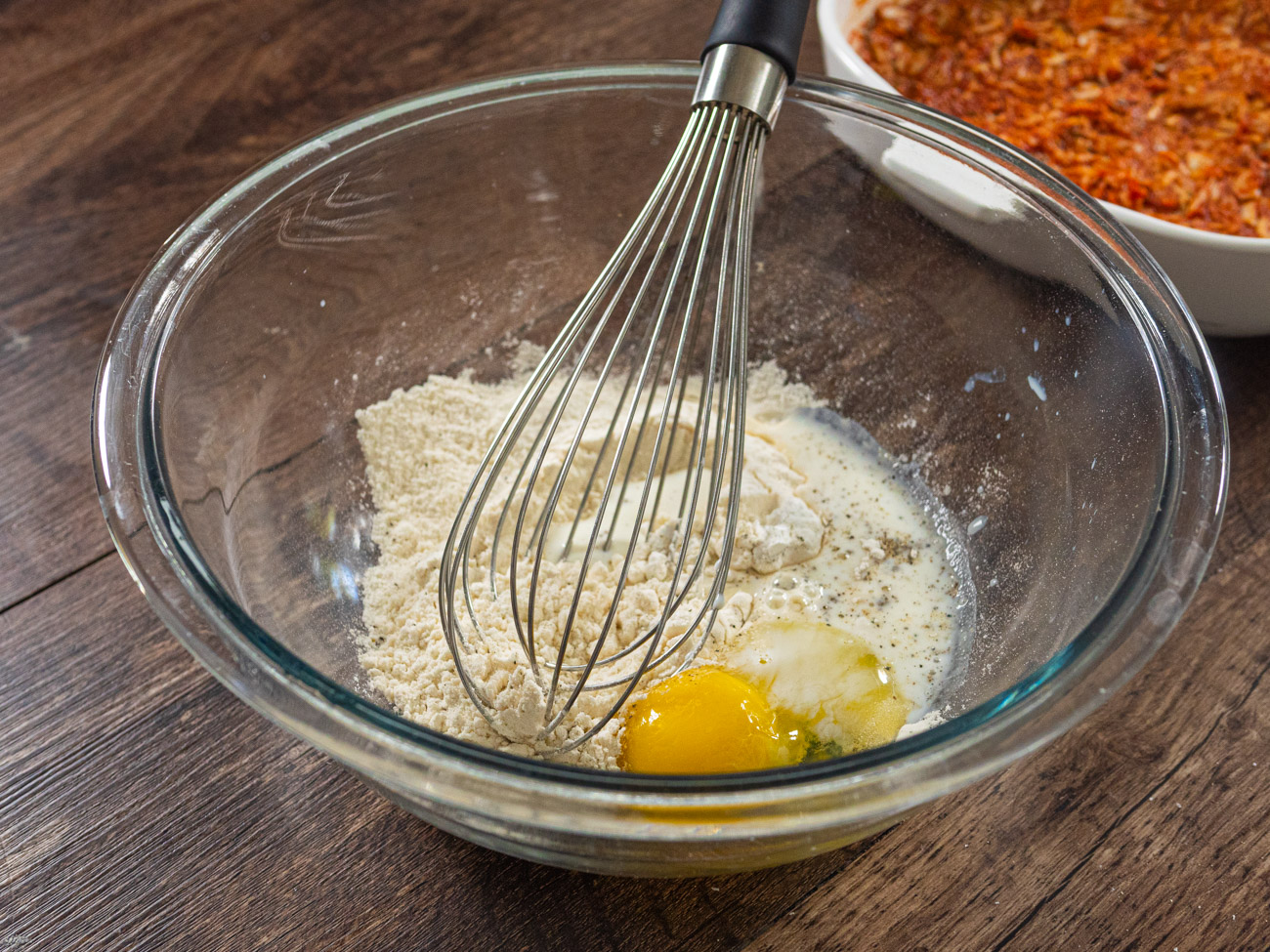 In a separate bowl combine flour, pepper, salt, and baking powder together. Add oil to dry ingredients and combine. Then add milk and egg and stir until batter is just combined.