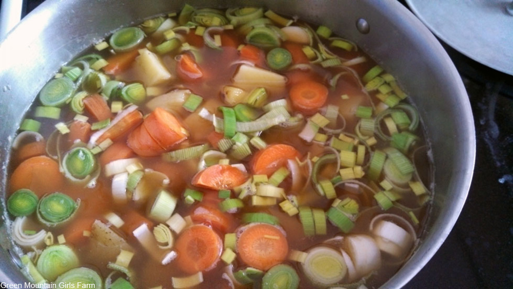 stock pot filled with broth and vegetables