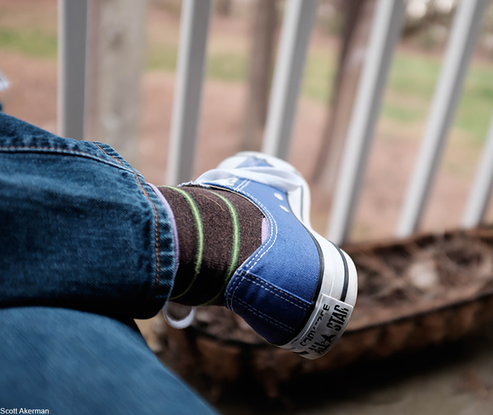 person wearing blue Converse All Star shoes