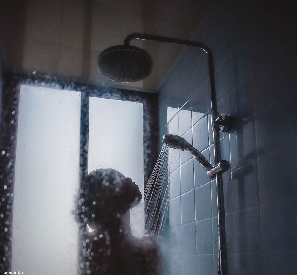 person showering in glass shower