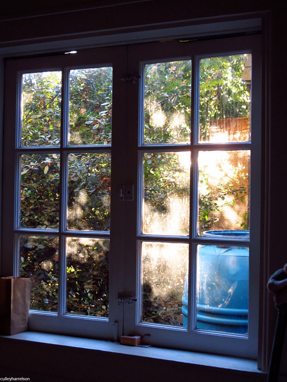 windows showing view of rain barrel outside