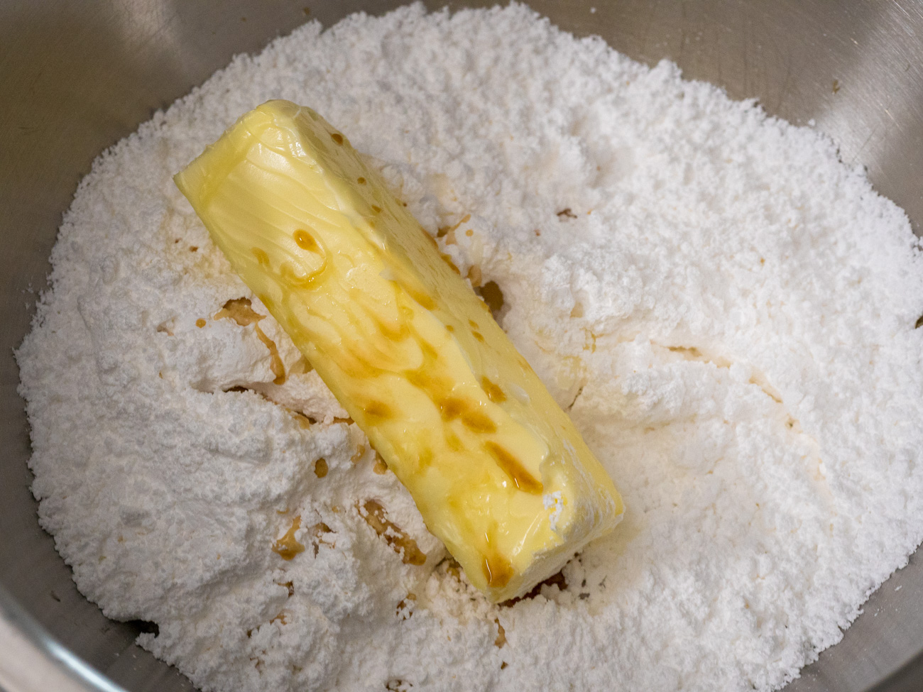 In a large mixing bowl combine powdered sugar and butter and then add 1 tablespoon milk and the vanilla. Mix well. If icing is too dry add one more tablespoon milk.