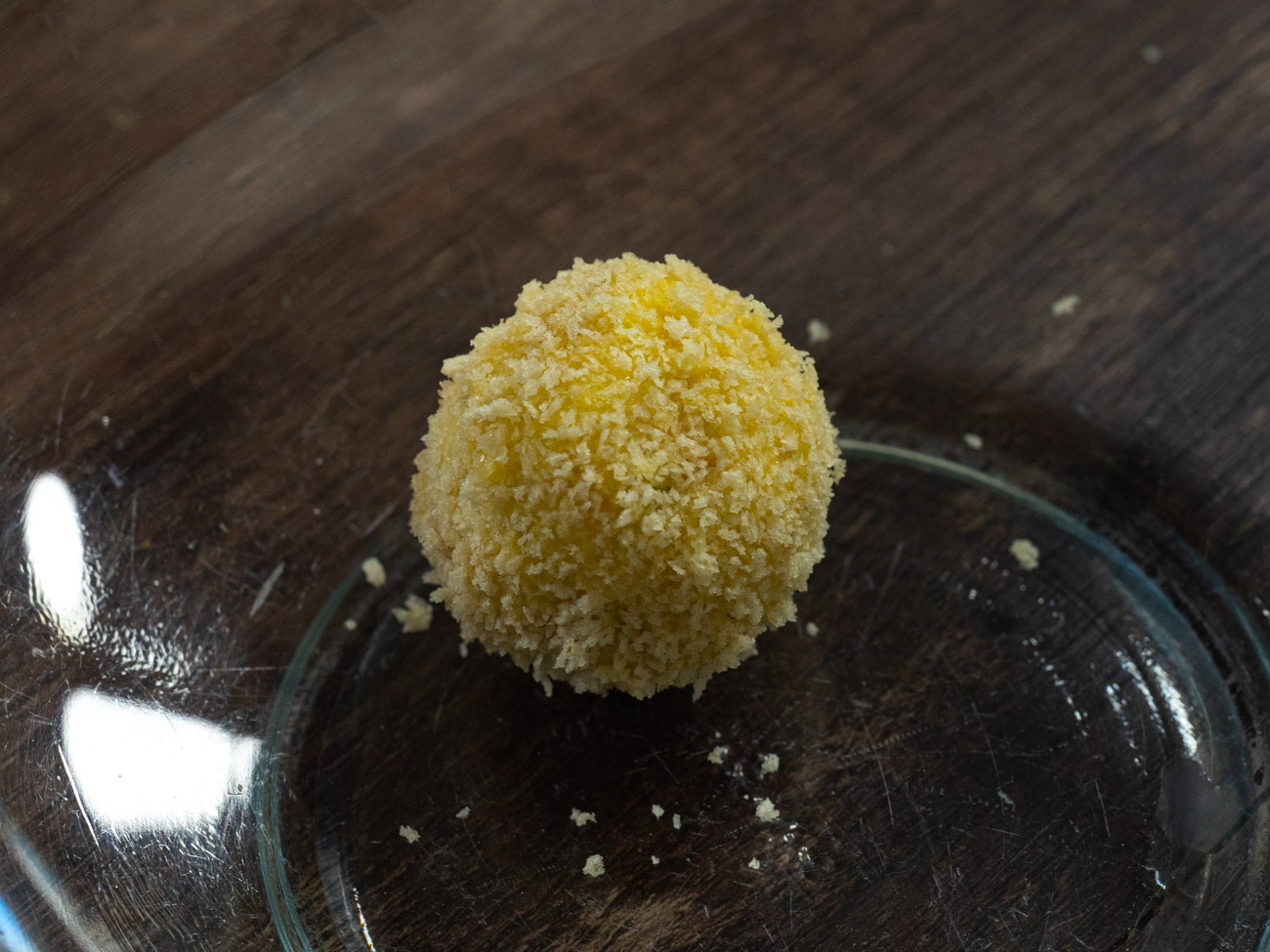 Using your hands, roll spoonfuls of the cooled grits into balls about 2 inches across. Dip fritters one at a time first into egg mixture and then into breadcrumbs before frying.