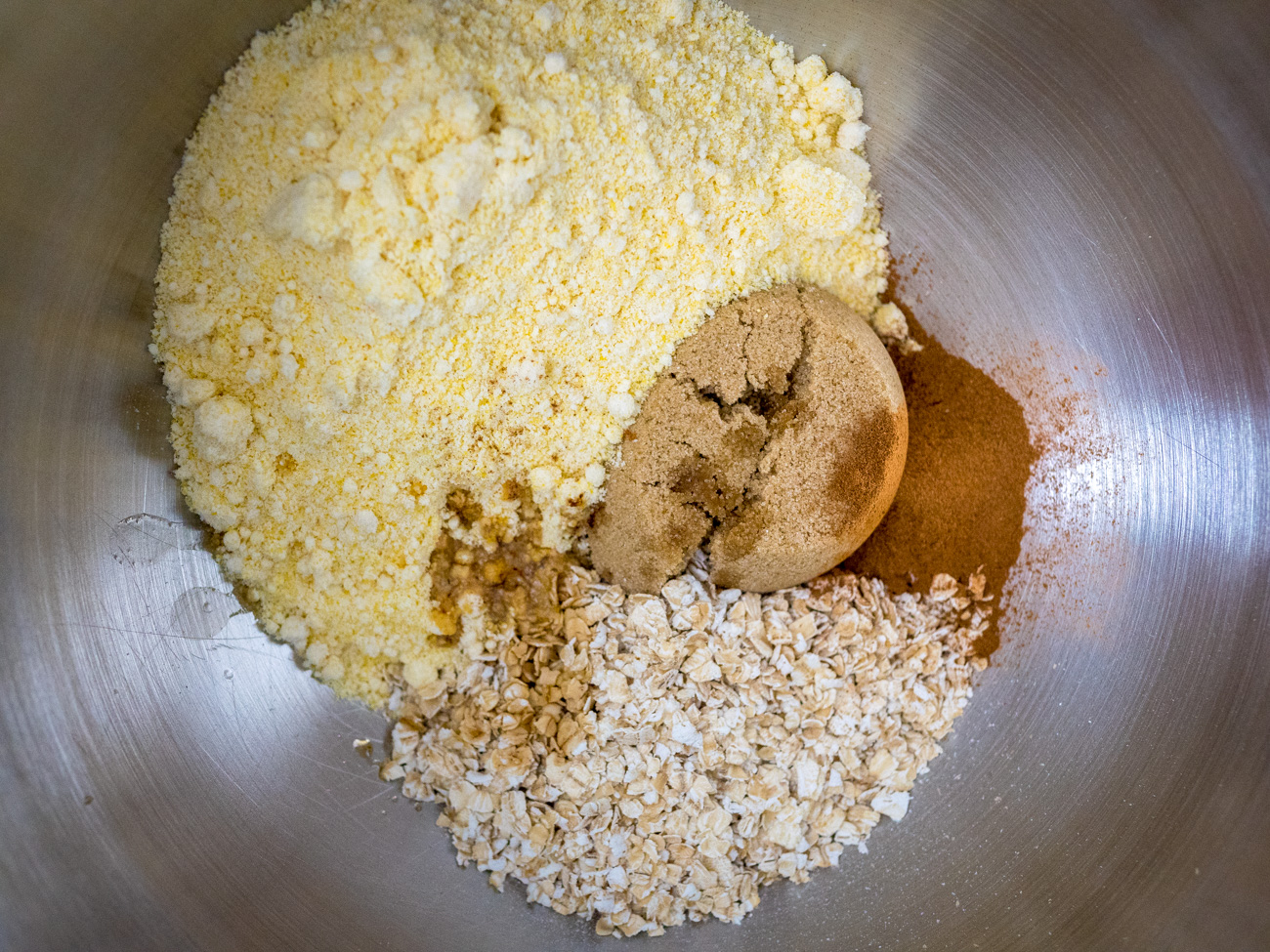 In a separate large bowl combine oats, cornbread mix, cinnamon, vanilla, and brown sugar. Cut in butter with fork or pastry knife until crumbly.