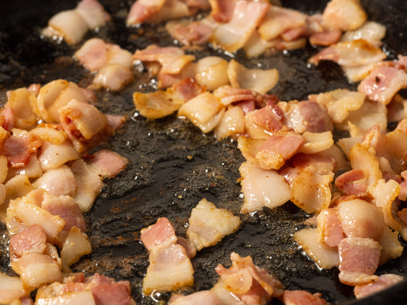 In the same pan fry the chopped bacon, and remove to a paper towel-lined plate when crispy.