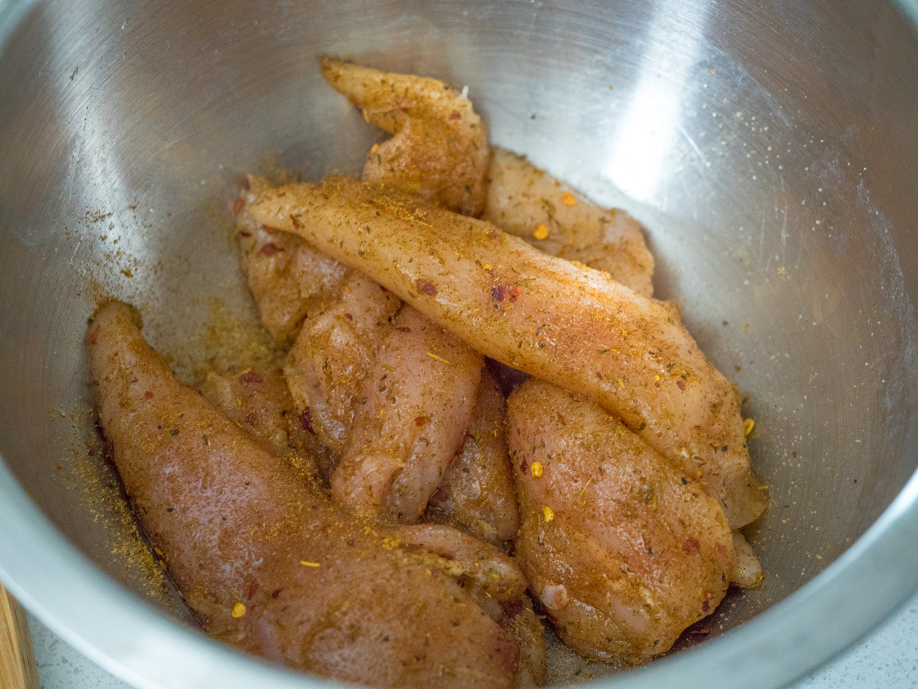 Place chicken in a bowl with jerk chicken mixture. Make sure all pieces are coated. Allow to marinate in the refrigerator (covered) for at least an hour or up to overnight.