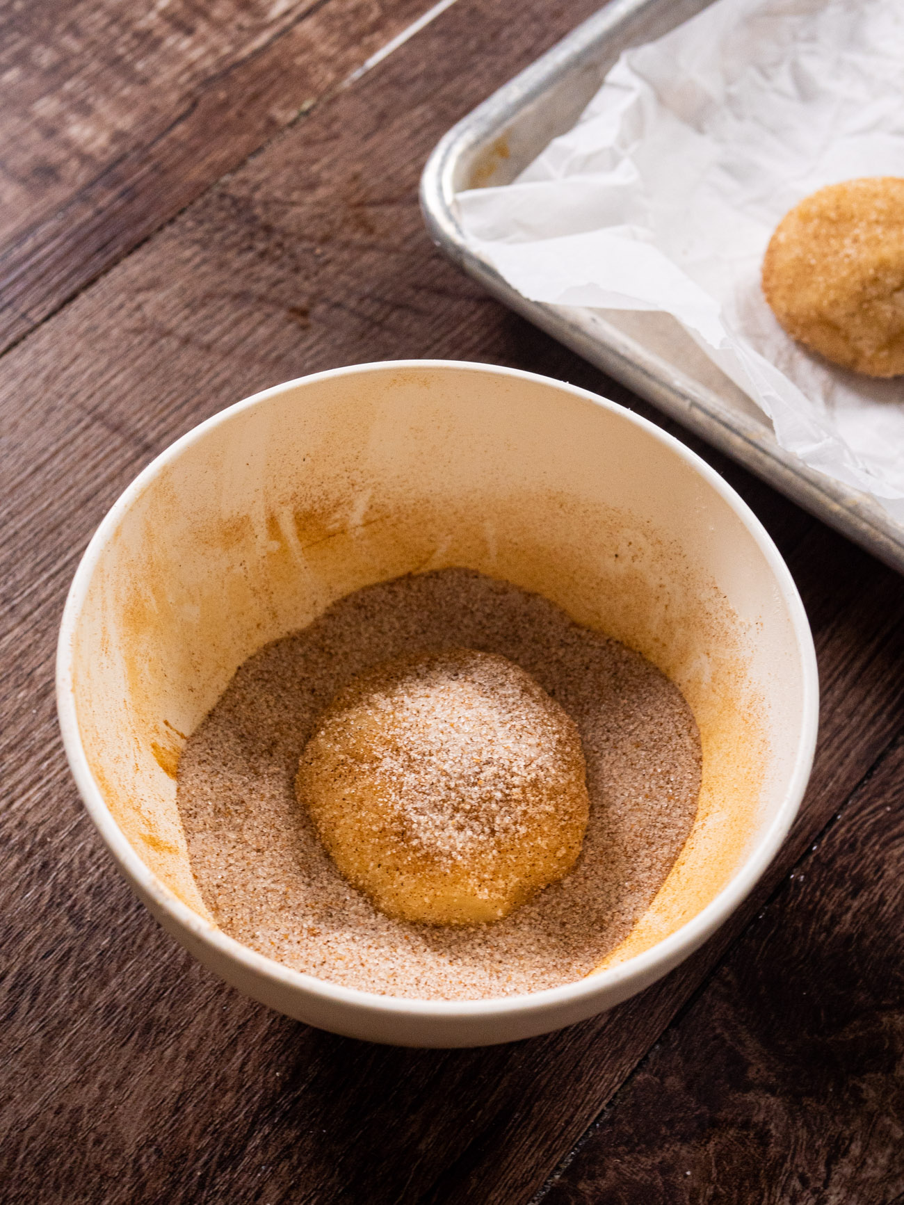 Roll balls in cinnamon sugar, place on a baking tray, and bake on the center rack 11 minutes. They'll look underdone when you take them out, so let them cool about 10 minutes on the baking tray and they will firm up as they cool.