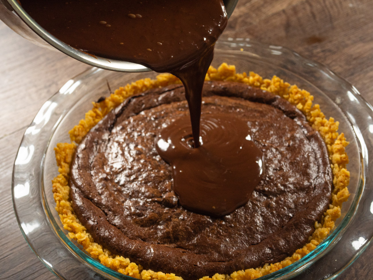 Into a small saucepan pour remaining cream and chocolate chips and stir over medium-low heat until well blended to make the ganache. Do not overheat. Pour ganache over the top of pie. Smooth topping with offset spatula, butter knife, or frosting knife for a level finish.