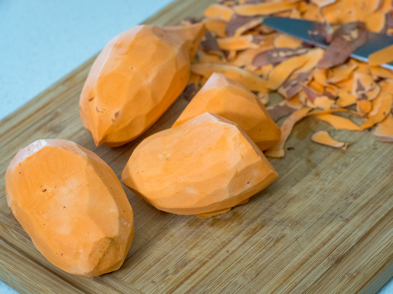 chopped sweet potatoes on a cutting board