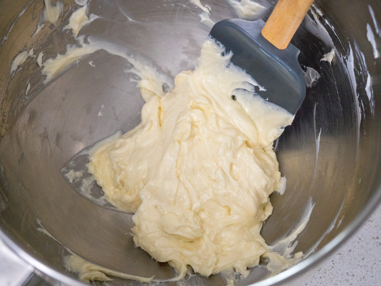 In a large bowl, combine cream cheese, vanilla, and powdered sugar with a hand mixer or a stand mixer.
