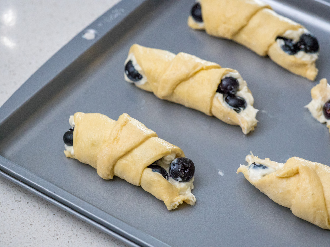 Place the finished roll onto a baking sheet and repeat with remaining ingredients to create 8 rolls.