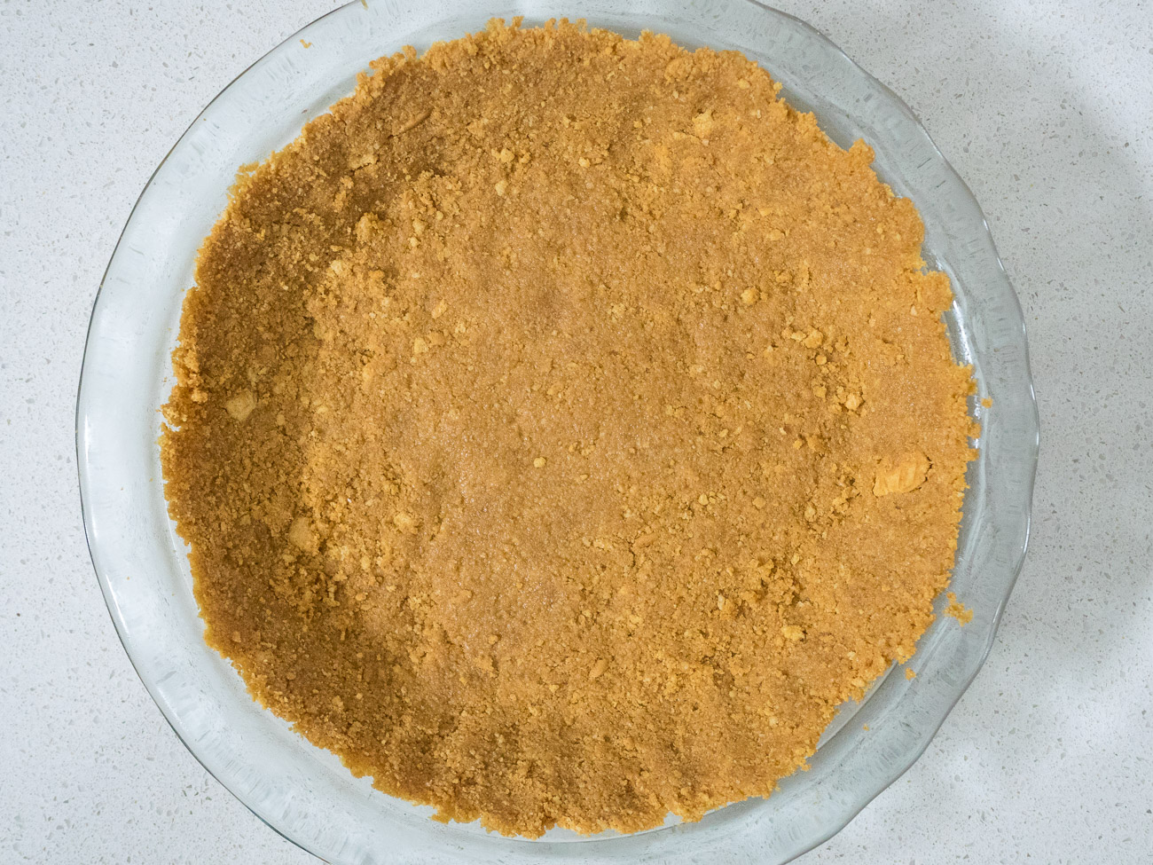 In a medium bowl majority of combine cookie crumbs with melted butter. Press into bottom and sides of greased 9-inch pie pan.