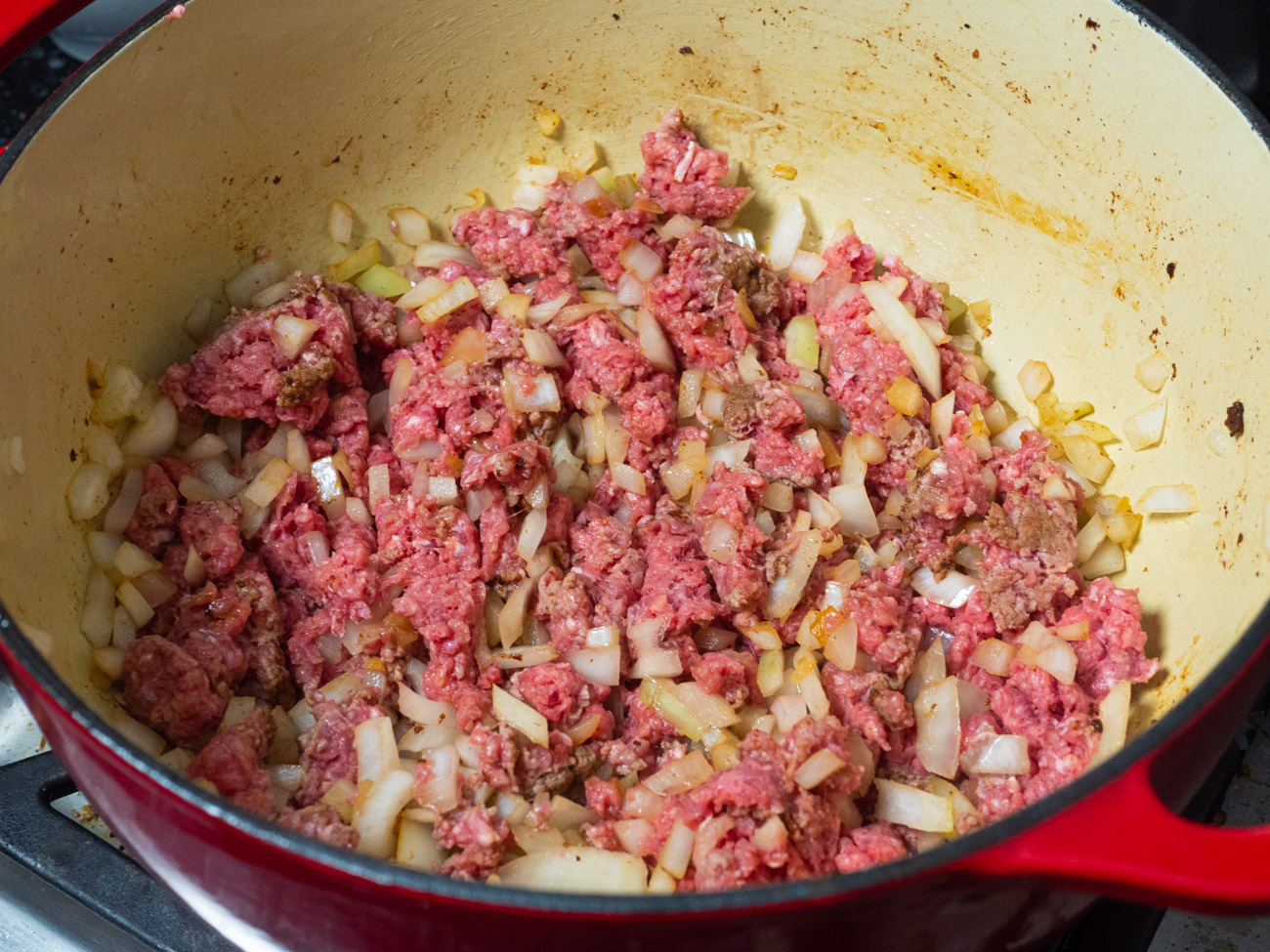 Add beef and onion to pot and cook until beef is no longer pink. Add garlic and cook 1 minute more.