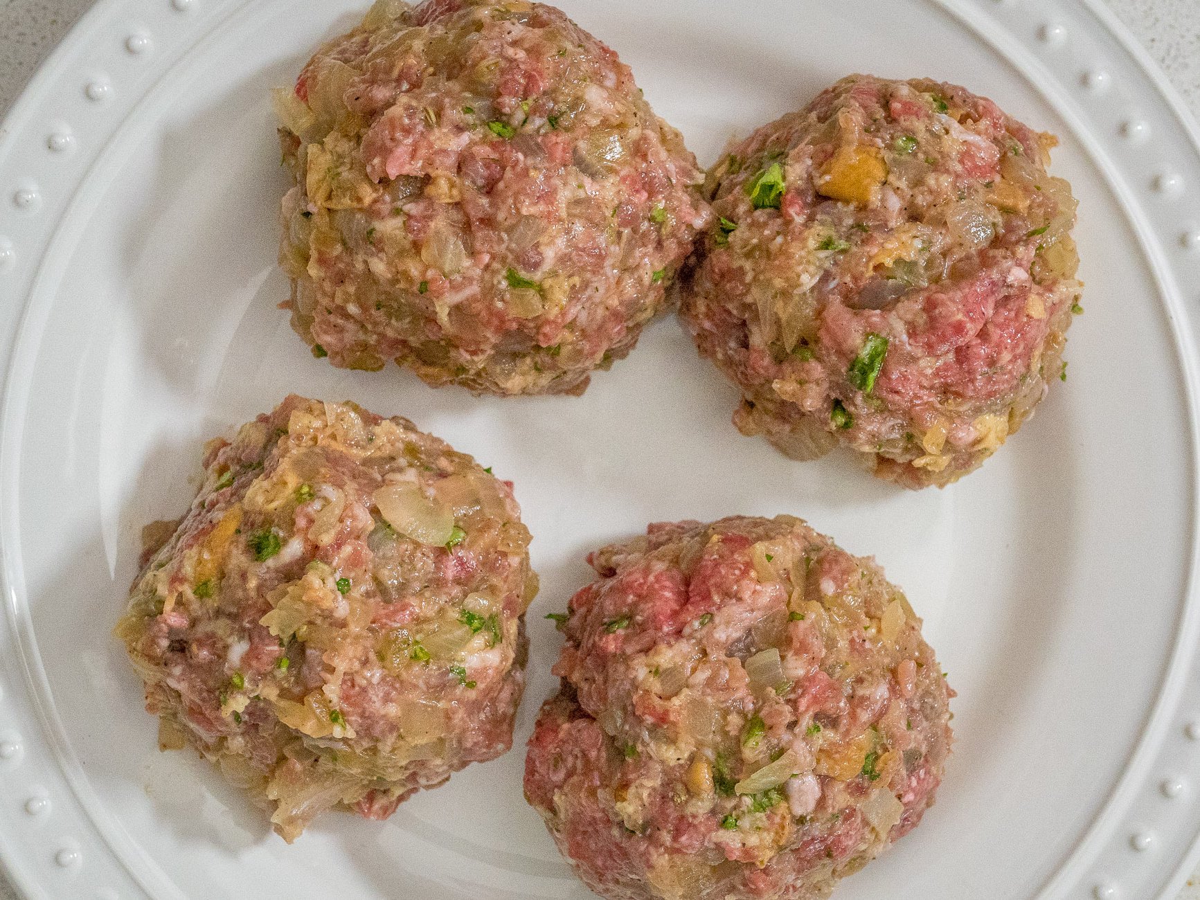 Knead mixture until completely blended. Divide into 4 equal parts and shape into balls. Then slightly flatten the frikadellen into patties. Chill patties for 30 minutes.