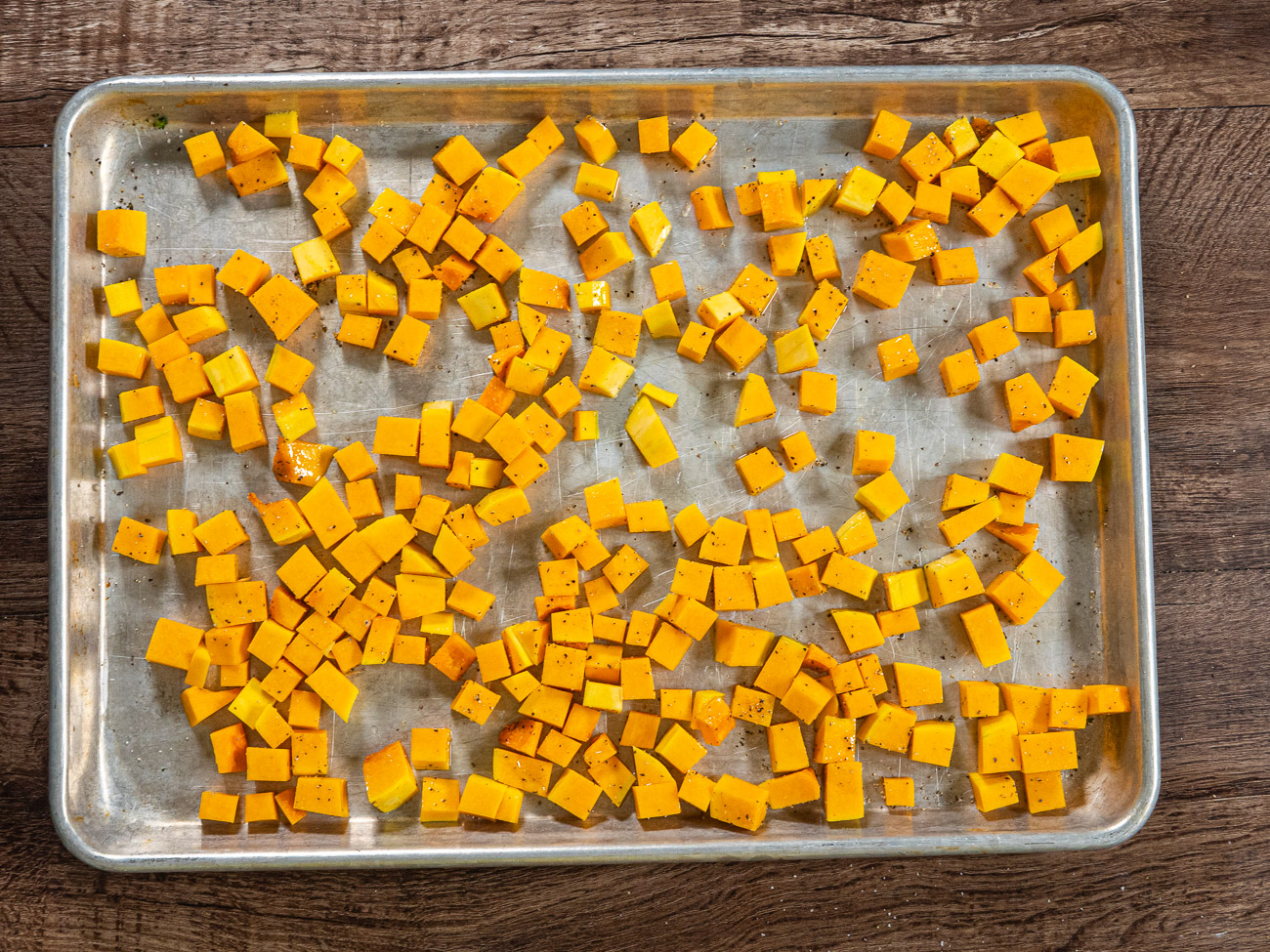 Arrange butternut squash on a baking sheet and drizzle with olive oil. Season with salt and pepper and toss to combine. Bake until pierced easily with a fork, about 30 minutes.