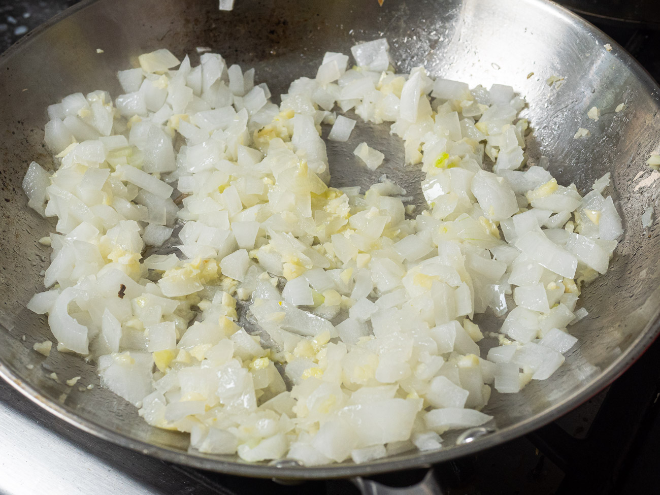 Place a large skillet over medium heat. Add olive oil and saute onion until soft and translucent, 3-4 minutes. Add garlic and cook 1 minute more.