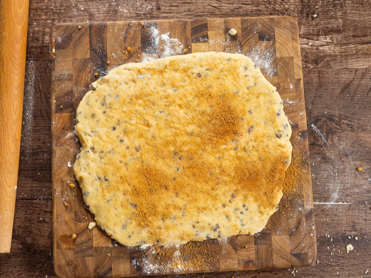 Roll dough out to a 12”x12” size on countertop. Brush dough with water and sprinkle reserved cinnamon and brown sugar on top.