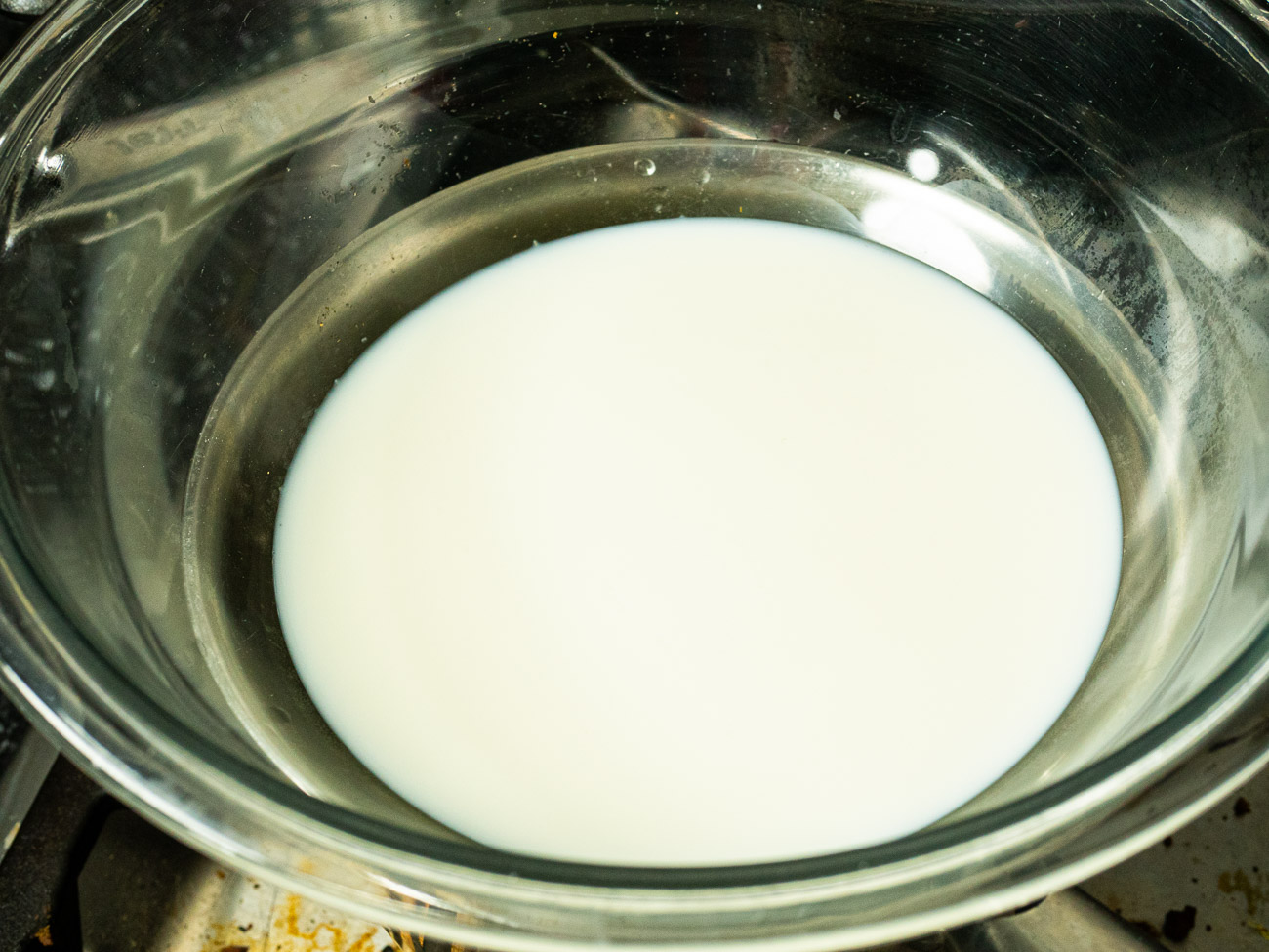 Using a double boiler heat 1 cup milk over medium-low heat until just beginning to froth.