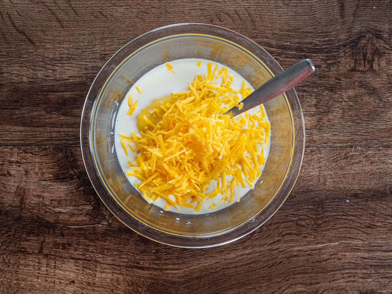 In a small bowl, mix together milk, soup, and cheese. Spread 1/3 cup of mixture in prepared baking dish.