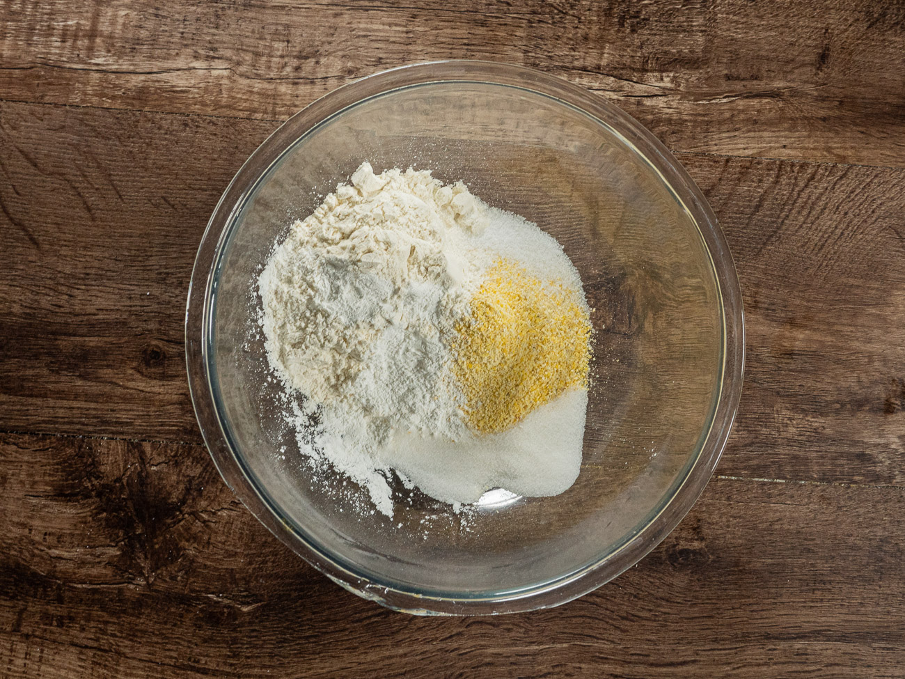 In a large bowl, whisk together cornmeal, flour, baking powder, salt, and sugar.