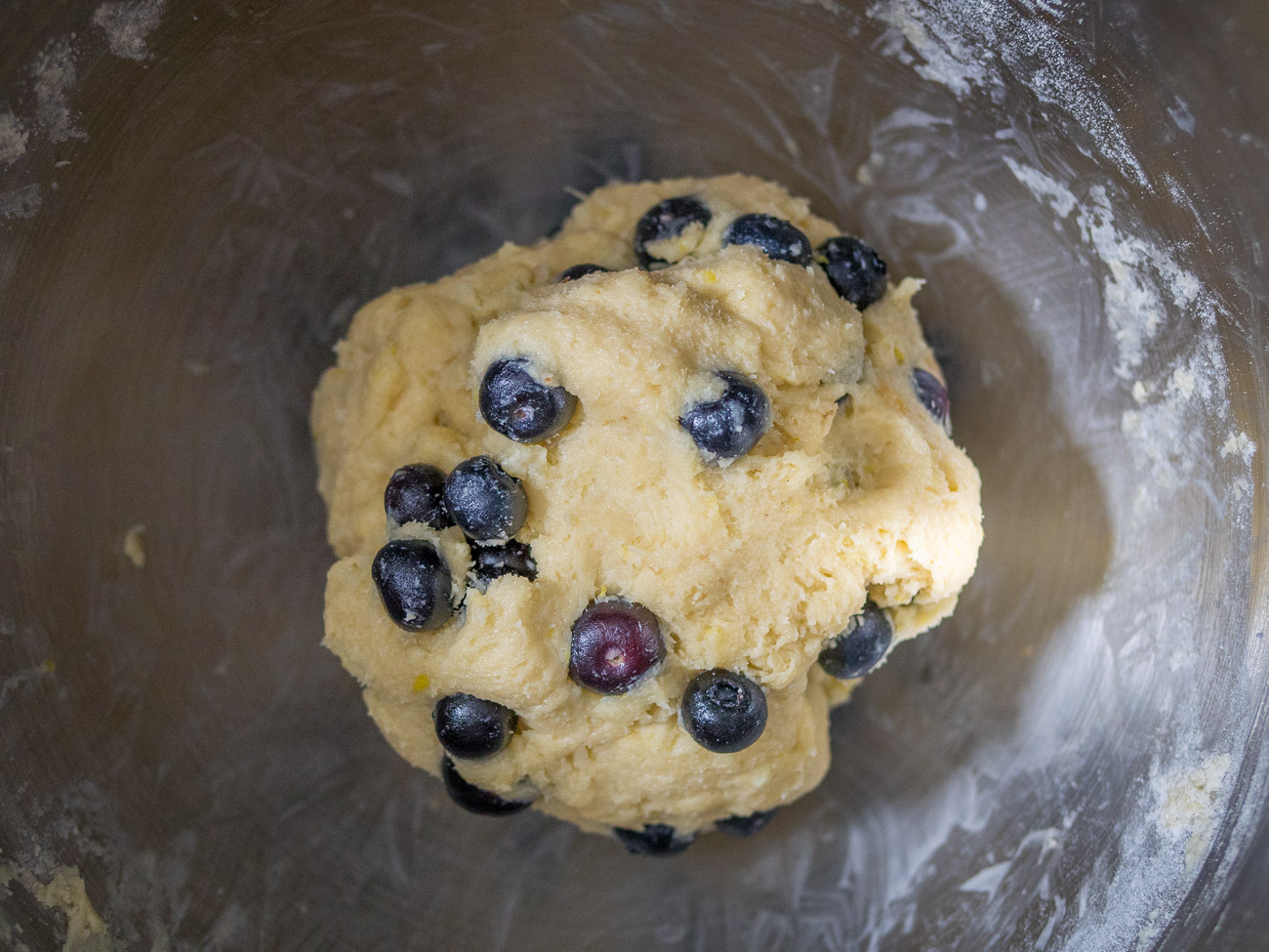 In a medium bowl whisk together cream, egg, and vanilla. Slowly add this mixture to the flour and butter blend. Dough will be thick. Gently fold in blueberries.