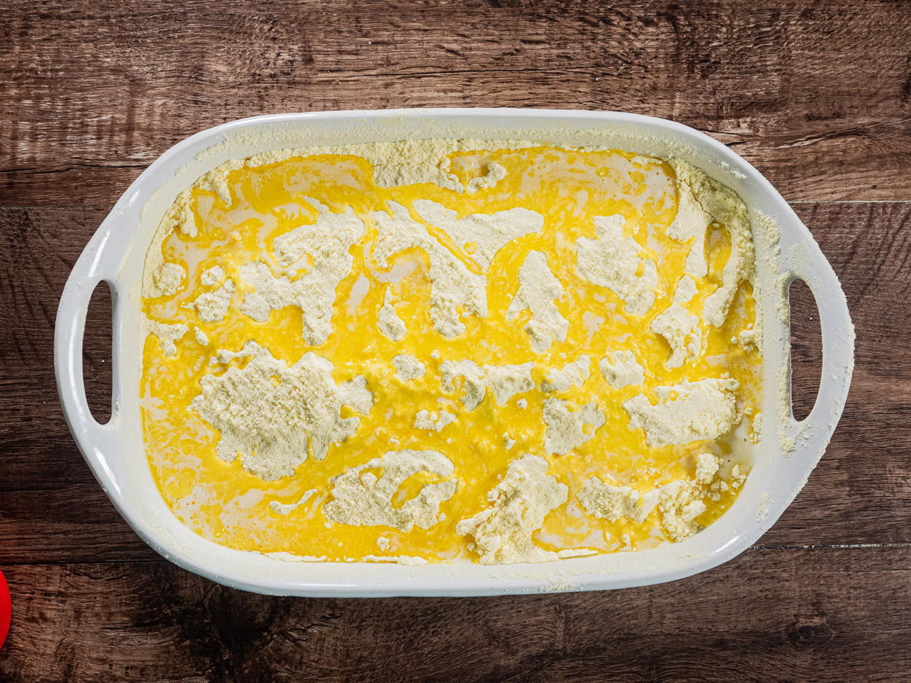 Sift entire box of cake mix on top of pumpkin batter. Make sure the mix reaches to the edges of the pan. Pour melted butter over the top.