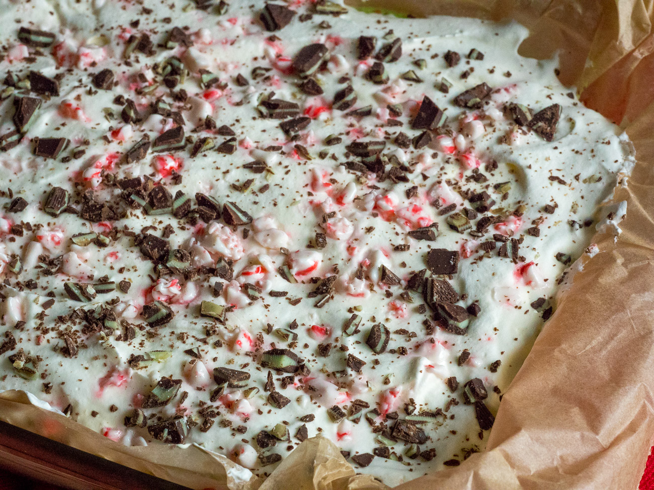 Spread cool whip over the green layer and sprinkle remaining crushed peppermints and mint chocolate chips on top. Store in the fridge until ready to eat.