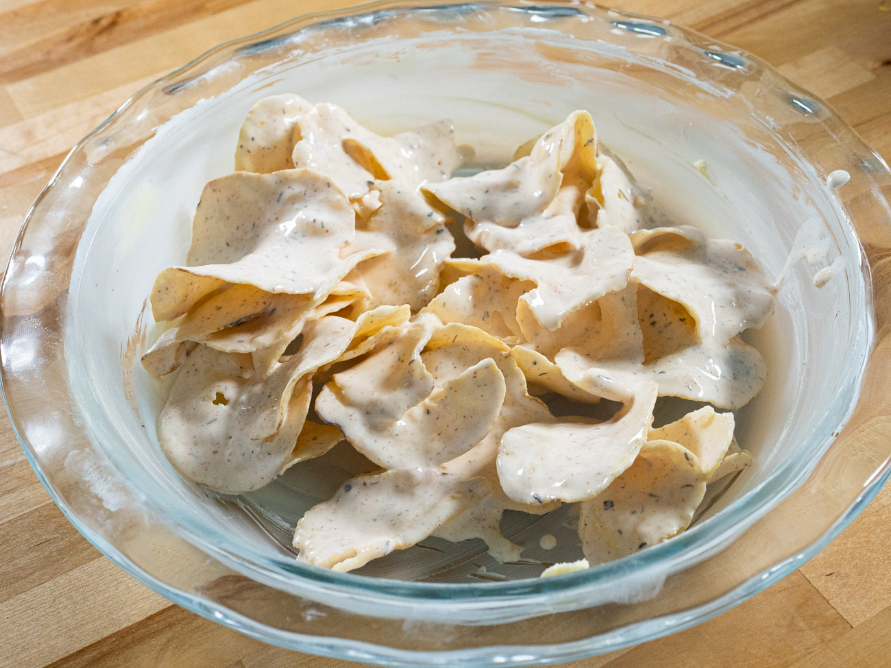 Add 2 cups potato chips to cream mixture and very gently toss to coat the chips, but do not break them.