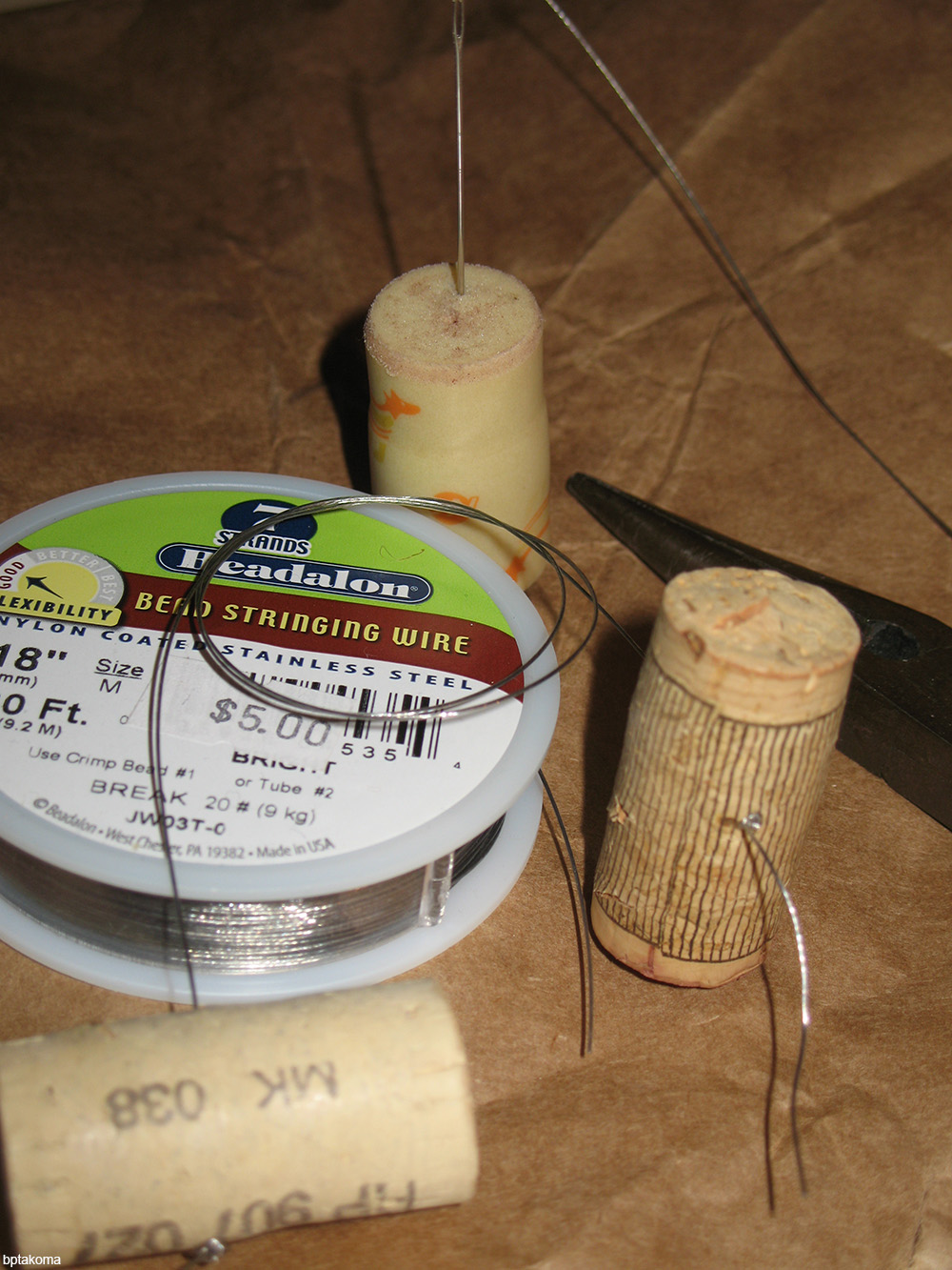 corks being used to hold sewing needles