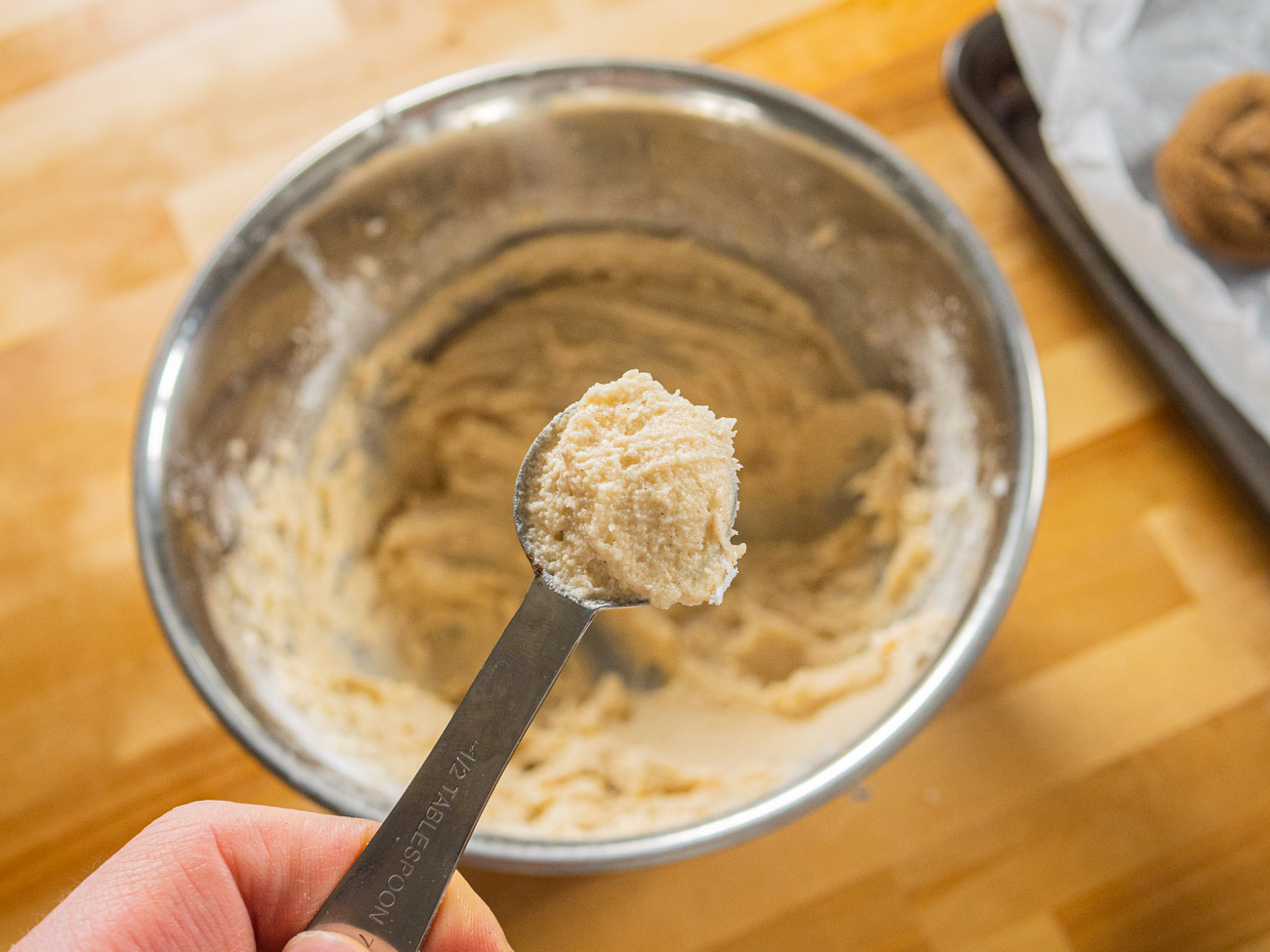 Scoop a 2 teaspoon ball of dough into your hands and roll.