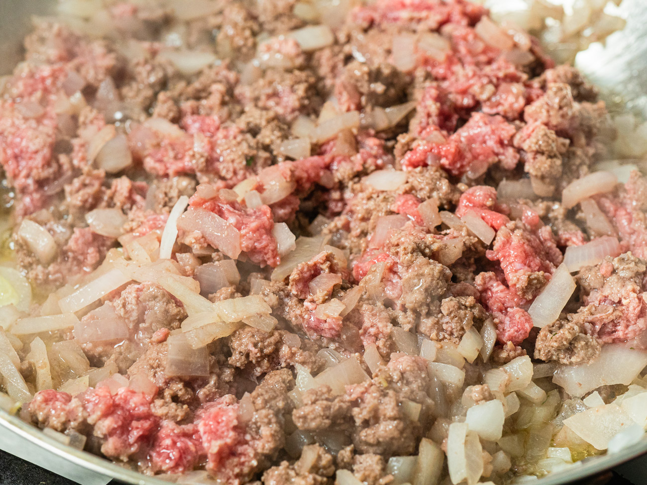 ground beef being browned in a pan