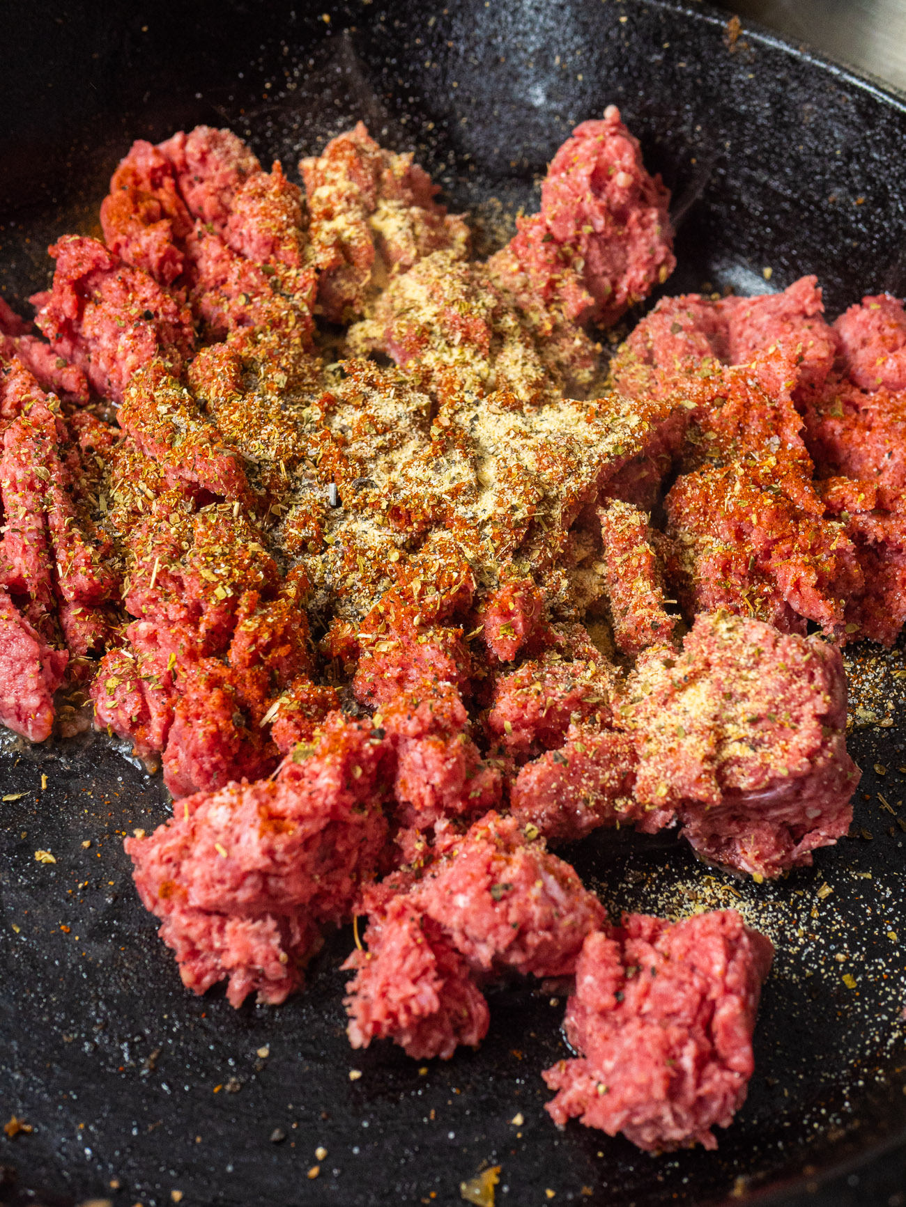 ground beef in a cast iron skillet with spices