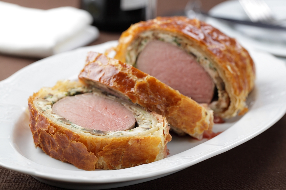 Beef Wellington sliced on a platter