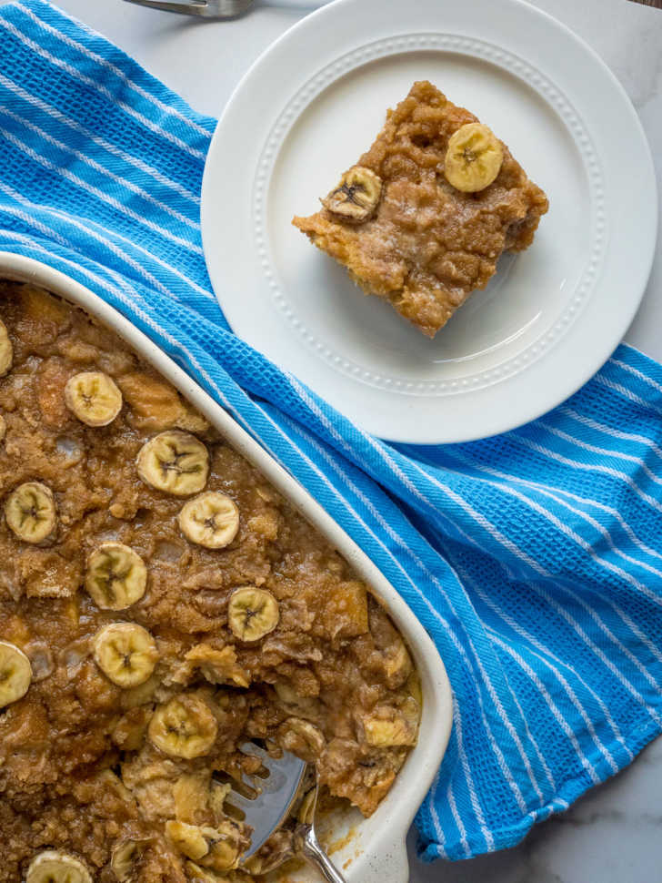 Top down photo of french toast casserole in a pan and on a plate with bananas on top