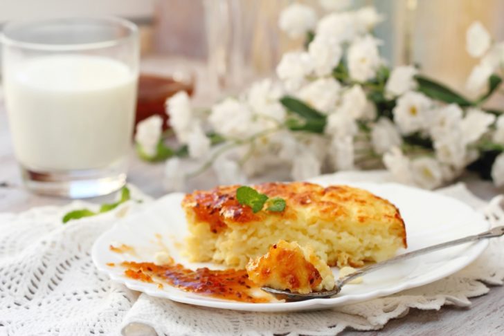 Portion of cottage cheese casserole with orange jam