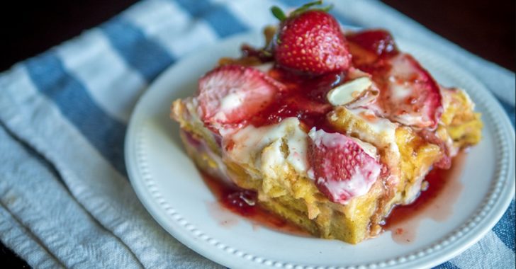 Close up of strawberry french toast casserole with icing on top