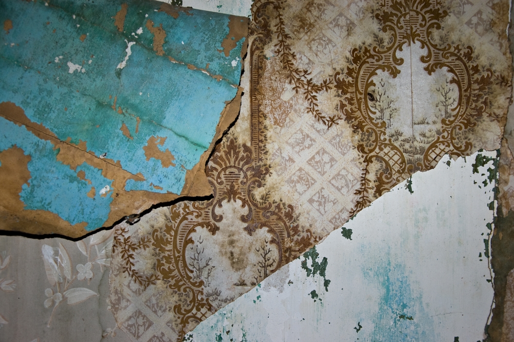 layers of peeling wallpaper in an abandoned house