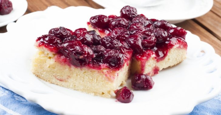 Dense white cake with dark red cherry topping