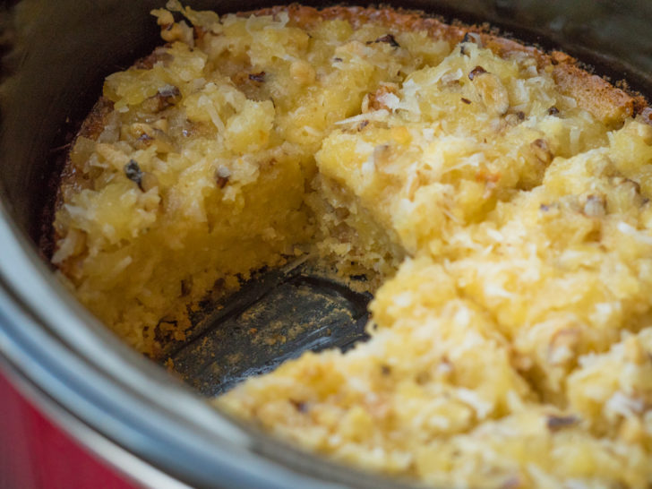 Close up of slow cooker with pineapple spoon cake inside