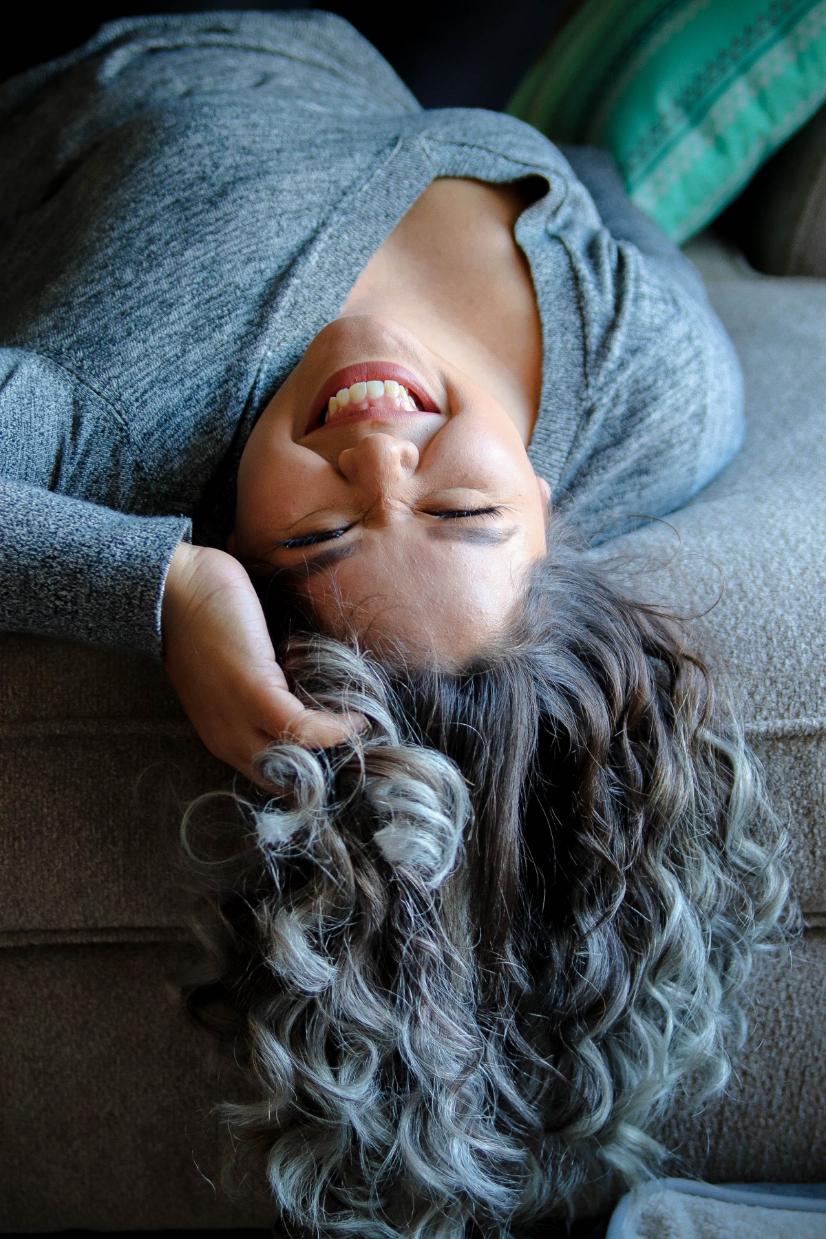 woman with long, curly, partially grey hair