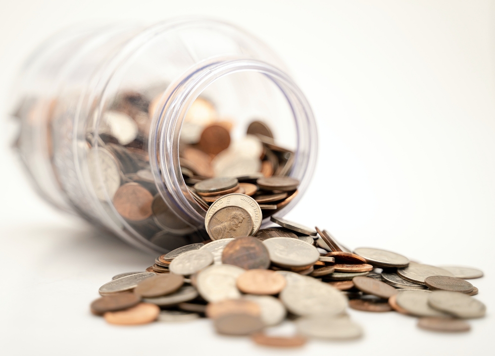 spilled change jar on white background