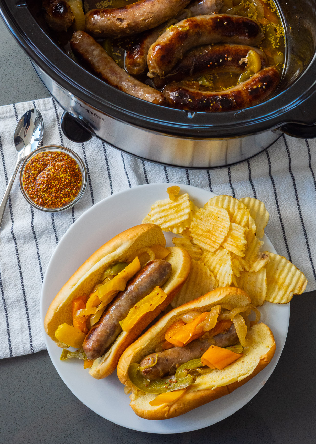 Slow Cooker Brats with Onions and Peppers - Cooking With Carlee